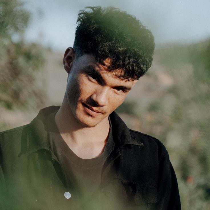 Ava Shah, Lead Design Curator at Pollen Canvas Crest, reviewing corporate floral arrangements